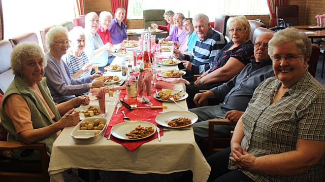 Residents from Threlkeld Court serve up a treat for their friends from Clough Court 