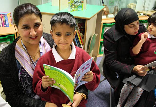 Parents in the new library reading with their children