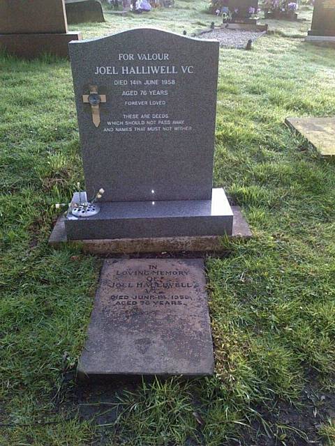 The modern gravestone of Lance Corporal Joel Halliwell - the original is seen in the foreground of the plot