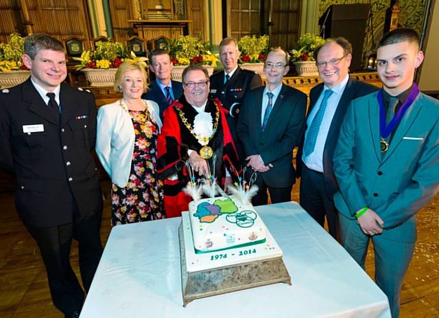 The Mayor Councillor Peter Rush prepares to cut the cake, marking four decades of the borough with (Left to right) Chief Superintendent Chris Sykes, Mayoress Monica Rush, Chief Executive Jim Taylor, Paul Starling Council Leader Colin Lambert, Deputy Police and Crime Commissioner Jim Battle and Leon Hollinrake, Member of Youth Parliament. 