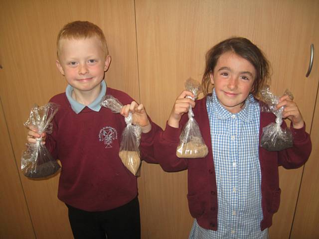 Kenzie and Ellie with the schools poppy seeds donated by local bussneses and Whitworth councillors