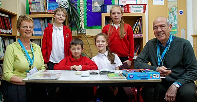 Pauline and Bernard Thompson with pupils at Newhey Community Primary School 