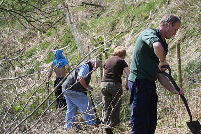 On Track members putting up the fence and planting the hedgerow