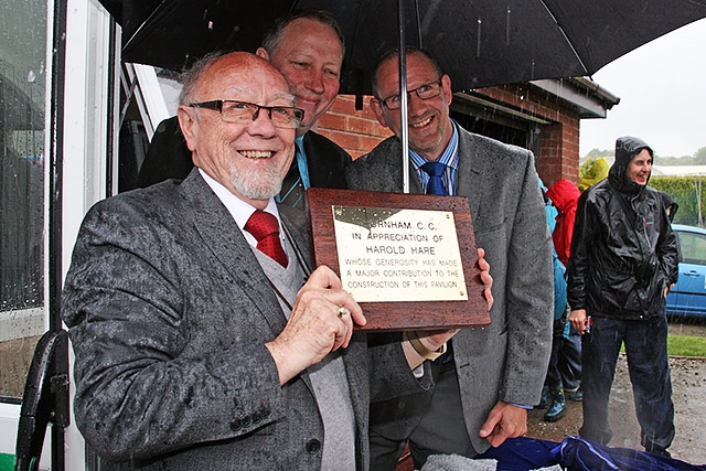 Jim Dobbin MP, Thornham Cricket Club President Kevin McMahon and Club Chairman Ian Heywood with a memorial plaque to Harold Hare 