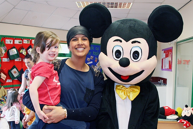 Imogen O'Brien, nursery manager Nadia Salim and Mickey Mouse