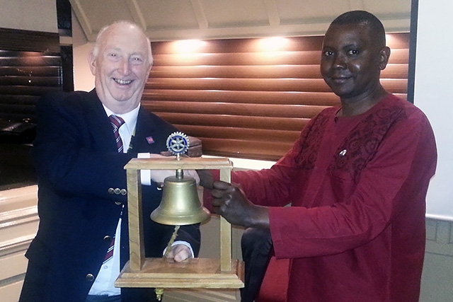 President of Middleton Rotary Club, Stuart Sawle presents regalia to Presidentof Rotary Club of Nkumba, Michale Muriithi