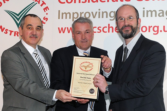 Steve Balyski Operations Manager and Jim Connell Contract Director receiving the National Site award from William Swan, Director of Constructing Excellence in the North West