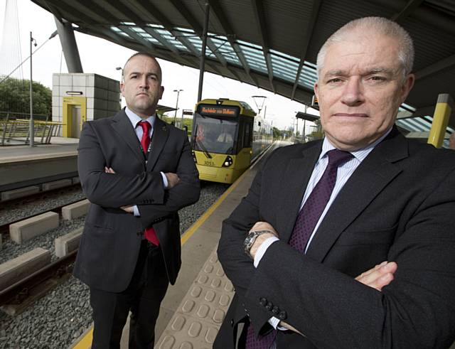 GMP Coordinator for Operation Alloy, John Woods and TfGM Metrolink Director, Peter Cushing at the Central Park Metrolink stop