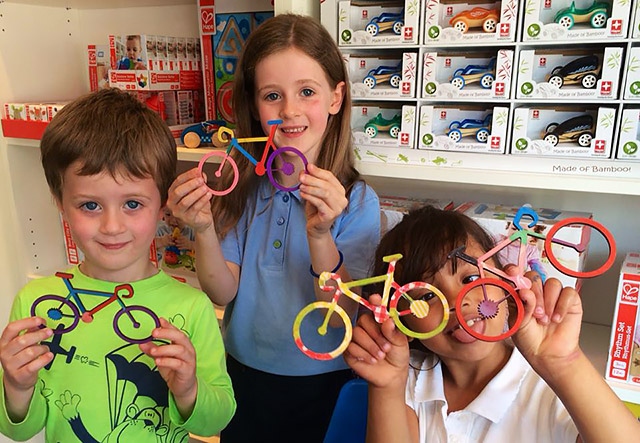 Children at the Star Tree Studio decorate wooden bicycles for the Tour de France