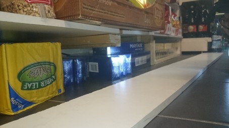 Cigarettes and Tobacco found underneath display stands