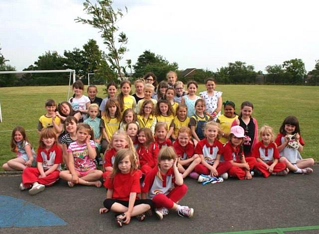 Members of St Margaret’s Rainbows, Brownies and Guides with their apple tree