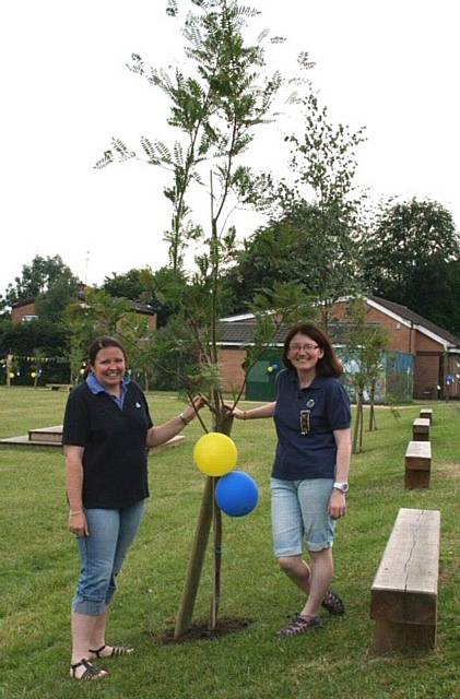 Leader’s Alison Quinn and Sarah Cadogan with the Guiding apple tree