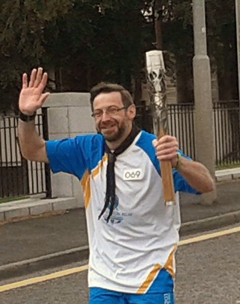 Michael Winn, a former resident of Milnrow, carries the Commonwealth Baton in Aberdeen 