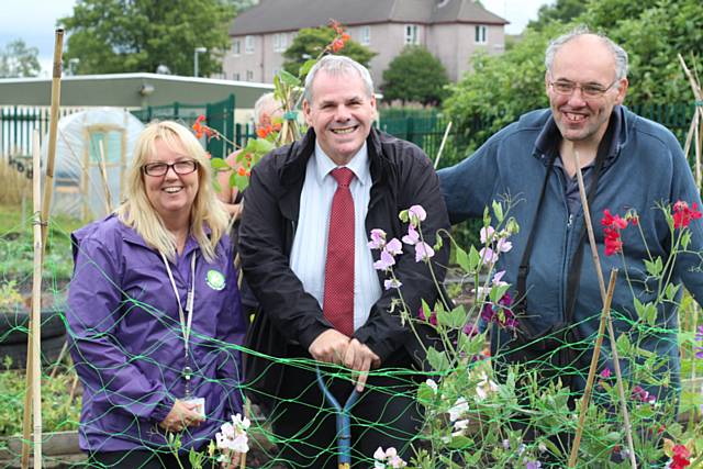 Local councillor Richard Farnell gets dug in with volunteers Ruth Sillence and Brian Yates