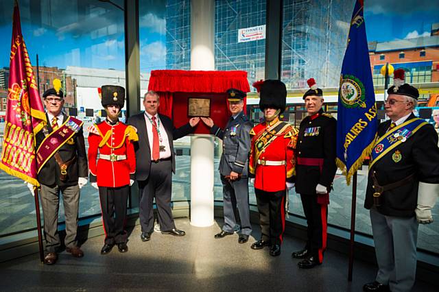 Cllr Richard Farnell (left) and Dr Jon Lamonte (right) unveil the plaque flanked by fusiliers
