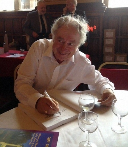 Ralph Davidson signing a copy of his new book