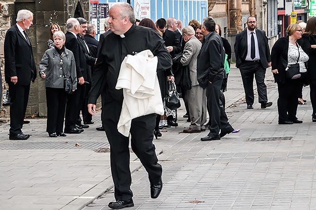 Father Paul Daly arriving for Jim Dobbin's funeral