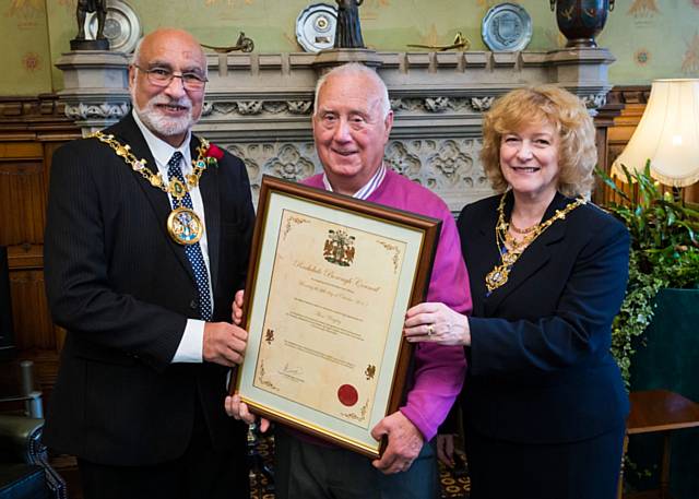 Alan Wrigley is presented with his Mayoral commendation by Mayor Surinder Biant and Mayoress Cecile Biant