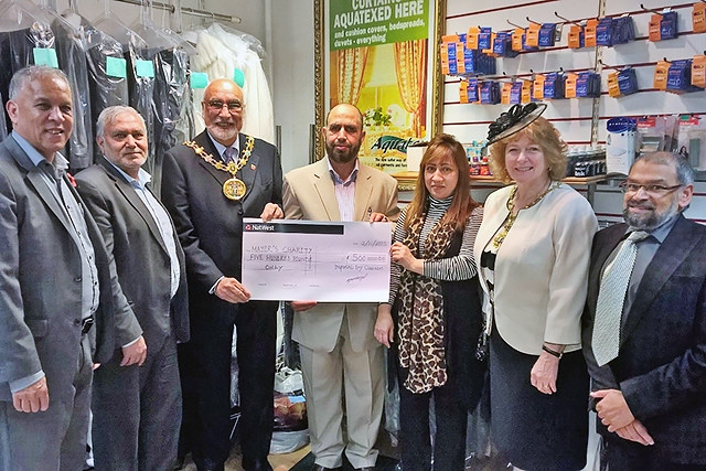 Mohammed Javed presenting a cheque for £500 to the Mayor and Mayoress