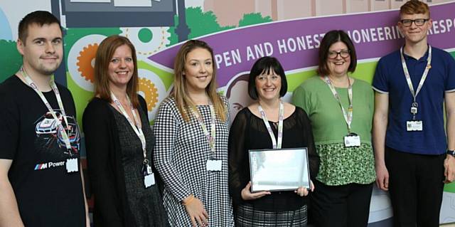 RBH Contact Centre Manager Joanne Hill with her award and some of her colleagues