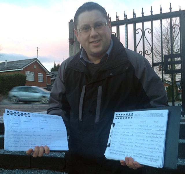 Cllr Peter Winkler with residents’ signatures collected in support of a permanent crossing point on Caldershaw Road