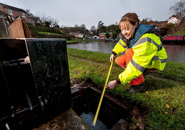 Canal & River Trust engineer Fran Littlewood surveys a canal sluice