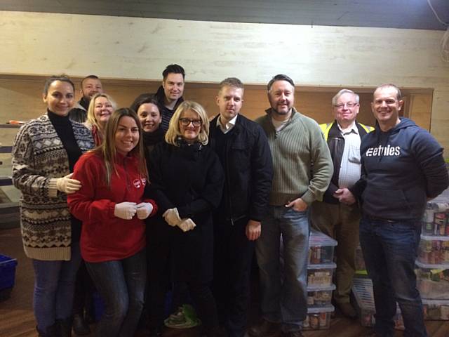 Stuart Watson, Foodbank Warehouse Manager (in the yellow hi-viz jacket), from BT: Julie Etheridge; Charlie Etheridge; Tania Caporaso (in the red jacket); Thomas Butler; Rachel Hancock; Rob Hewitt; Erika Hewitt and Deborah Anderson
