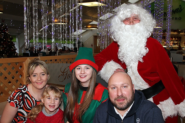 The Brett Family with Santa and his Elf