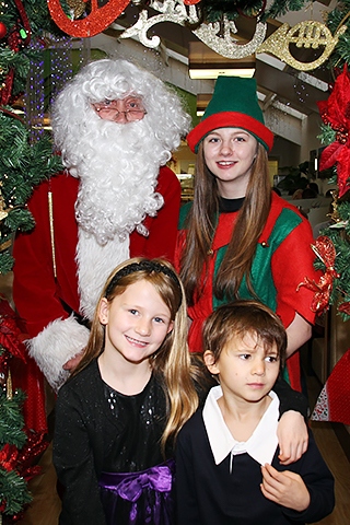 Isabel and Benjamin Williams with Santa and his Elf