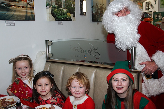 Abigail Lee, Millie Finn and Noah Ward with Santa and his Elf