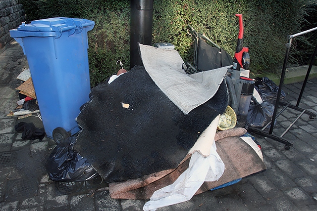 Flood damaged house contents in the street