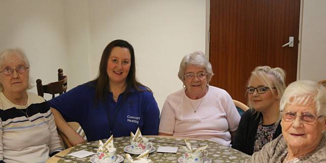 Diane Smeaton (second from left) from Concept Heating and RBH Project Development Officer Darrione-Rose Penlington (second from right) join Chisholm Court residents as they get ready for their celebratory lunch