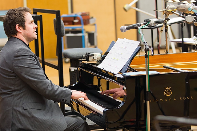 Phil Reynolds plays piano as the Rock Choir record at Abbey Road Studios