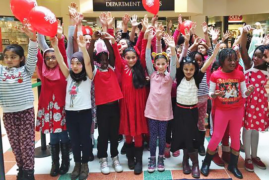 Broadfield Community Primary School choir singing in the Exchange Shopping Centre for Red Nose Day