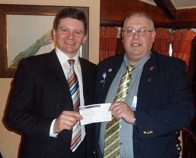 President elect Chris Kelly handing a Cheque for £500 to Phil Emmott from Recovery Republic