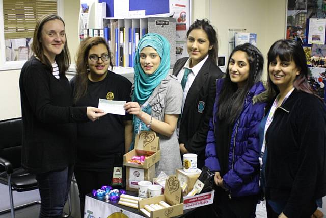 Anna Lee (left) hands over the donation to members of Not Just a Little Business and RBH Community Action Worker Khalida Crossley