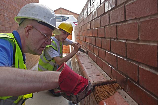 NEAT team members John Kershaw (left) and Nico finishing off brickwork