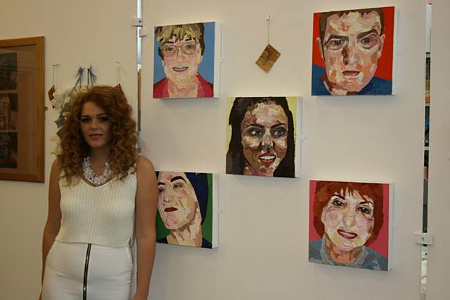 Lois McGee with her work which included creating a series of portraits 