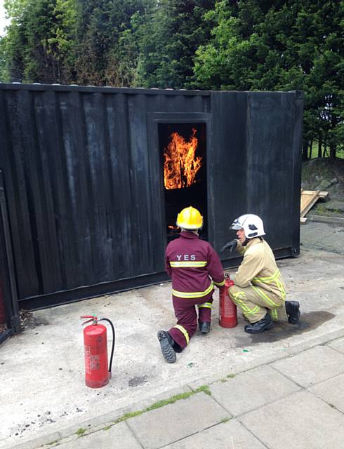 Holly Timmins is instructed on how to put out a fire