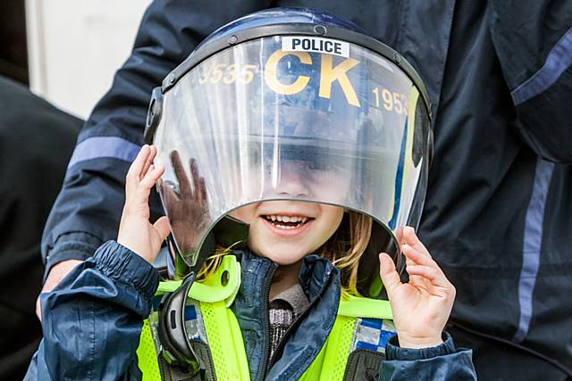 Isaac Journeaux tries out a police riot helmet at the Hollingworth Lake Dragon Boat day