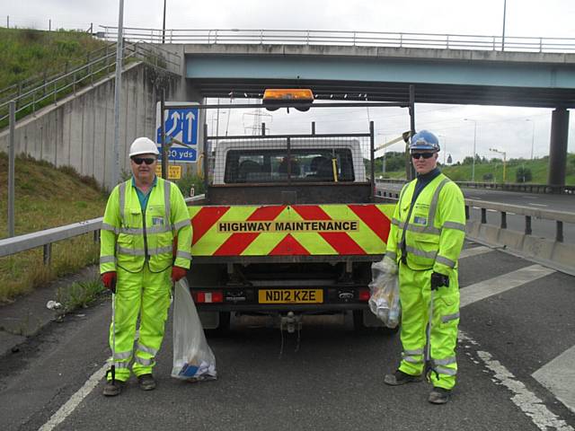 Workers collecting litter on the M60/M62 smart motorway scheme