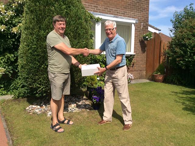 Club President Len Albon (right) handing over the shoe boxes to Rotary District Governor Nigel Danby