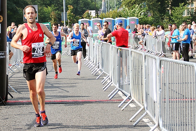 Dave Archer crosses the finish line to win the Rochdale Half Marathon 