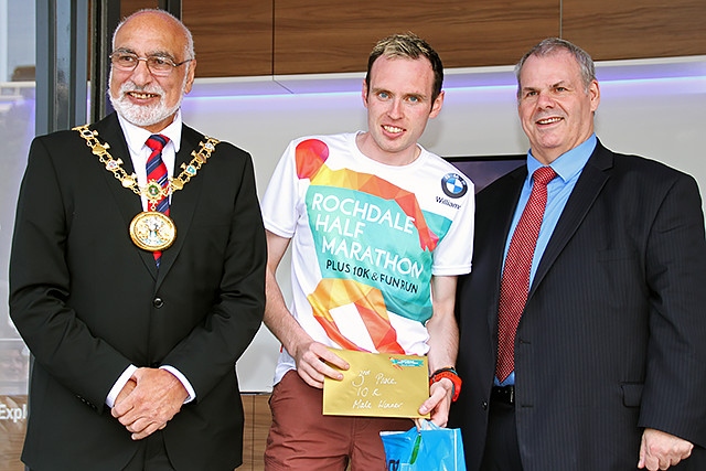 Rochdale 10k run third place runner Daniel Balshaw collects his prize