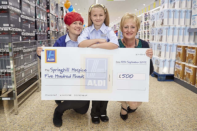 Store manager Sara Griffiths and Danielle Griffiths present Elaine McConnell from Springhill Hospice with a cheque for £500