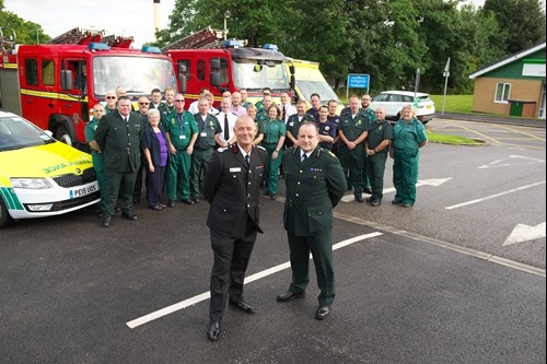 County Fire Officer and Chief Executive of GMFRS Peter O'Reilly and NWAS Head of Service Steve Hynes with staff from both GMFRS and NWAS at Highfield Ambulance Station in Farnworth