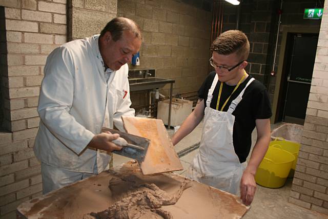 Plastering student Hayden Bates trying out the new facilities at Hopwood Hall College with lecture Rob Wilson