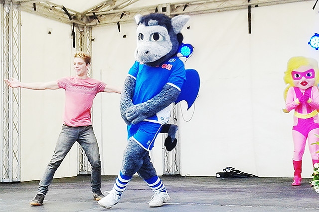 Roch Valley Radio dance off winners, Desmond the Dragon and Brad Paul, on the community stage at The Feel Good Festival