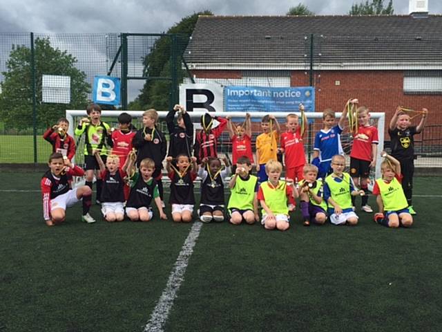 Hopwood Hall College’s community football under-8 players with Pennines Juniors FC.