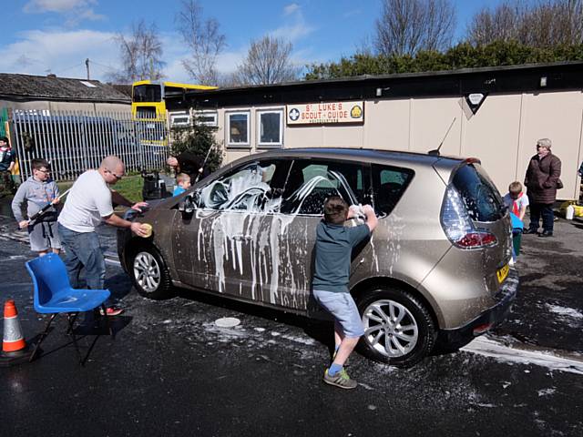 Beavers, cubs and scouts from the 8th Heywood Group wash cars to raise funds